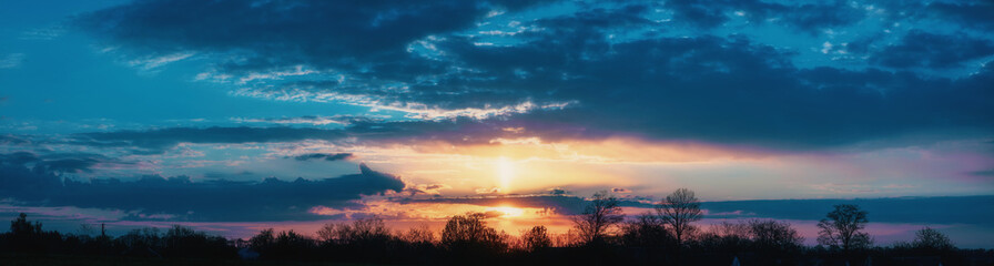 Fototapeta na wymiar Panorama of a beautiful sunset with clouds
