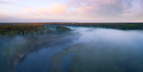Aerial panoramic landscape with sunset over the river with islands and beautiful clouds on the sky.