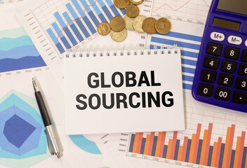 GLOBAL SOURCING. text on open notepad near wooden blocks on wooden table.