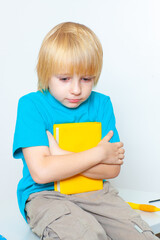 little boy with a book on a light background