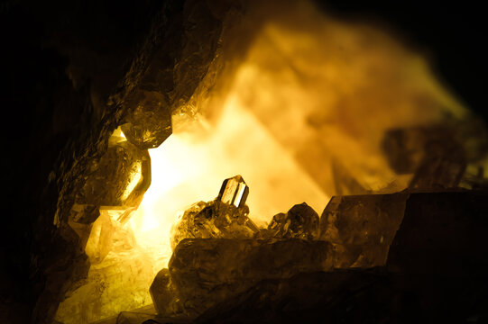 vesuvianite crystal backlit. macro detail texture background. close-up raw rough unpolished semi-precious gemstone 
