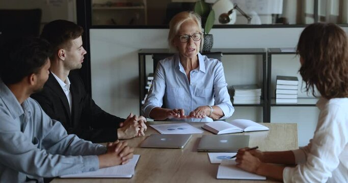 Formal meeting of business partners share strategy, gathered in boardroom. Employees listening older company boss take part in advisory, workshop. Financial department negotiate, take part in briefing