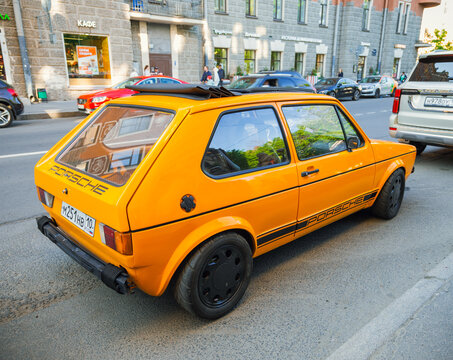 Classic German Volkswagen Golf Mk1 car of 1971, orange color, produced at the Porsche factory. Golf Mk1 was equipped with a 1.8-liter fuel-injected engine. VAG car. 