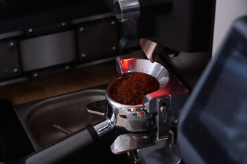 Fototapeta na wymiar Portafilter with coffee in coffee mashine