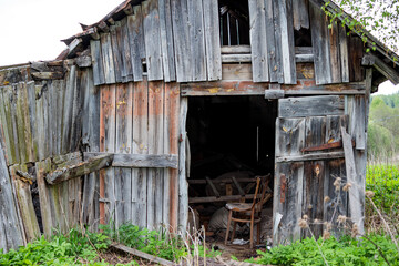 Old wooden rustic barn with various junk inside