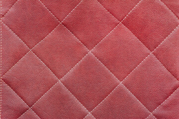 Fototapeta premium Texture, background of red natural leather sofa, wall.