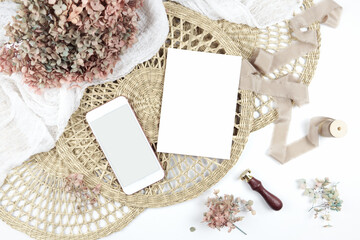 5x7 invitation greeting card, smart phone eVite. Wedding stationery suite mock-up styled with boho decor, dried hydrangea flowers bouquet, rattan lace mats, vintage wax seal, and silk ribbon.