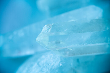 transparent crystals in blue tones.texture of gemstone.Rock crystal macro texture in blue light....