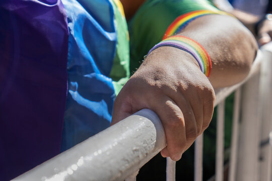 Embracing Love: A Gay Couple's Affection at Pride. LGBTQ, Rainbow flag, Diversity. Close up.