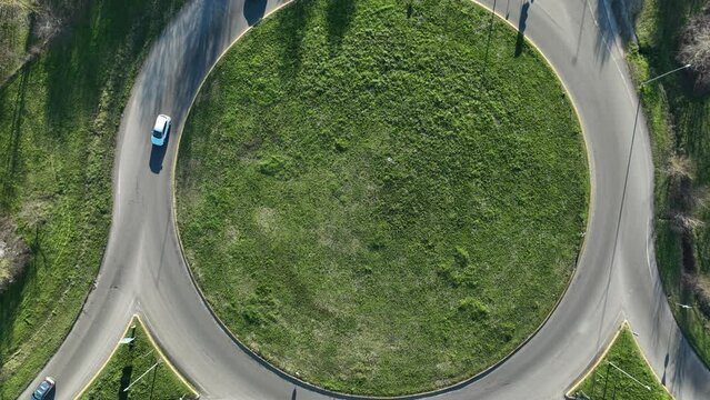 Time lapse aerial video: roundabout traffic of cars and trucks on the circle ring road aerial top view