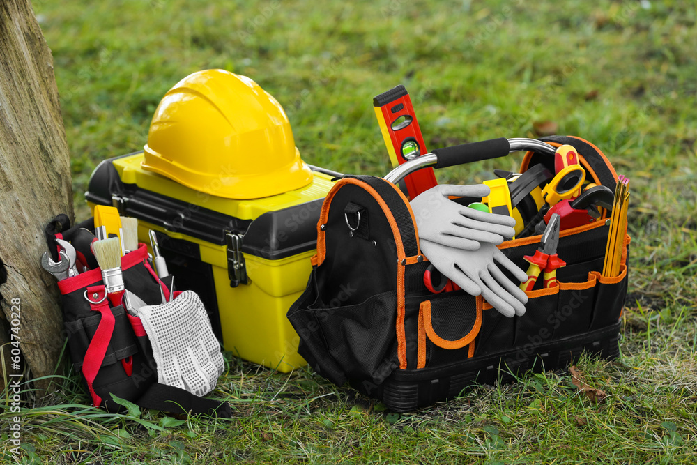 Canvas Prints Bag, belt and box with different tools for repair on grass near tree outdoors