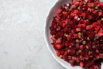 Delicious fresh vinaigrette salad on light grey table, top view. Space for text