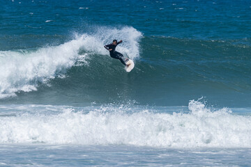 Surfer riding waves in Furadouro Beach