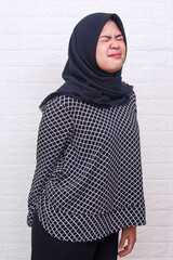 Muslim woman hand holding her bottom because having Abdominal pain and Hemorrhoids. Woman suffering...