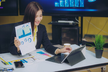 Businesswoman holding graph to analyze marketing plan turnover and profit Tax calculation with...