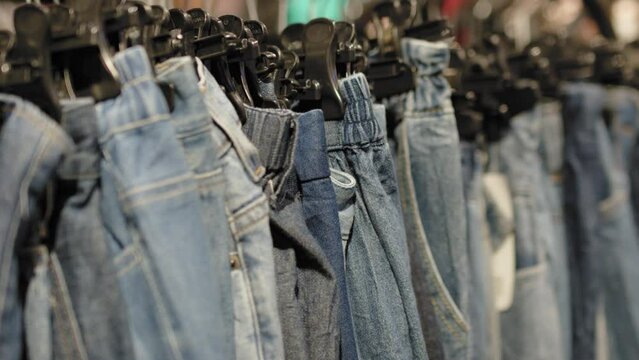 Rack of seconds hand jeans in local store, close up view
