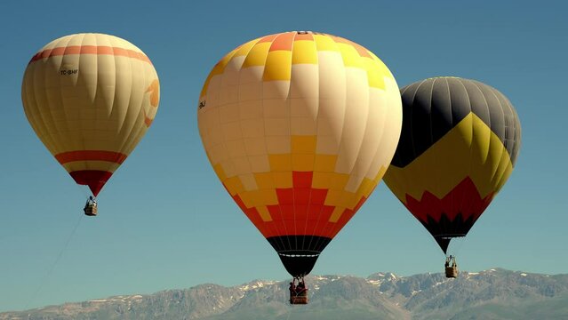Aerial view of Goreme. Colorful hot air balloons fly over the valley