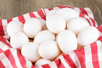Close up of  a basket of fresh raw White Eggs
