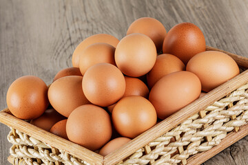 Close up of a basket of fresh raw Brown Eggs