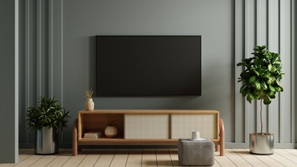 Living room on dark blue wall background with mockup a TV wall mounted.3d rendering