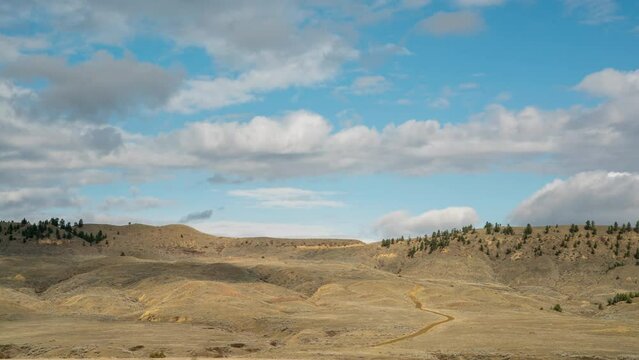 Timelapse of clouds rolling over prairie afternoon landscape