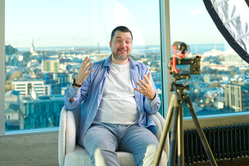 Man making business video blog. Vlogger finance advisor management information. Happy young social media blogger man, making videos for vlog © Ilja