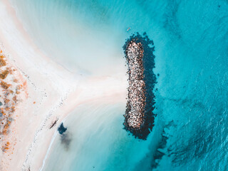 Aerial view of beautiful tropical turquoise ocean sea waters with shallow waves on the breakwater. Vibrant bright sunny day in summer wallpaper. Seascape background. Coastal wallpaper.