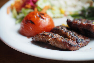 Kebab, traditional turkish meat food with salad on a plate 