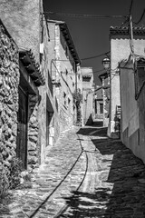 Picturesque and narrow alley of old stone houses in the village of Anento, Zaragoza.