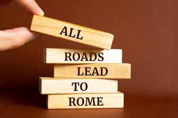 Wooden blocks with words 'All roads lead to Rome'.