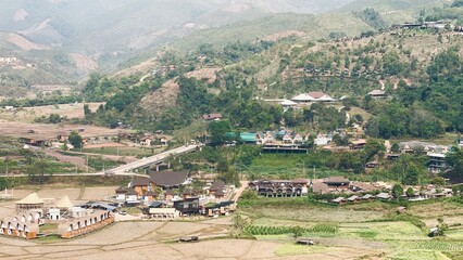 Valley village in mountains landscape.