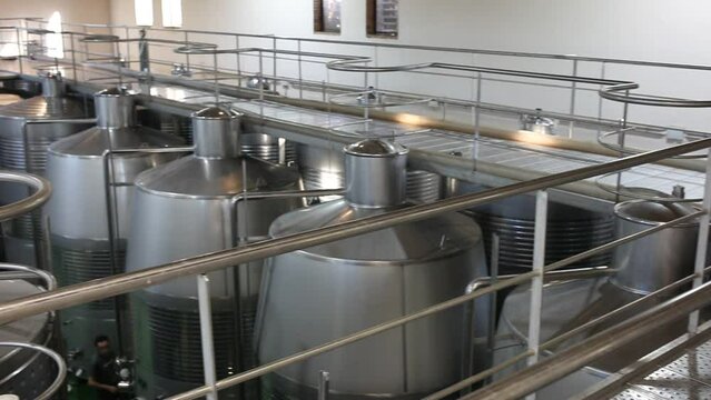 Interior of modern winery with stainless steel tanks for wine fermentation