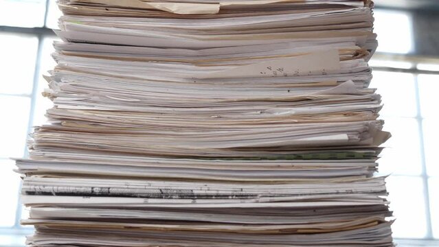A very large stack of papers. Deadline, office overload, bureaucracy, paperwork
