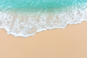 Fototapeta na wymiar Summer beach concept - Soft wave of sea on empty sandy beach Background with copy space..