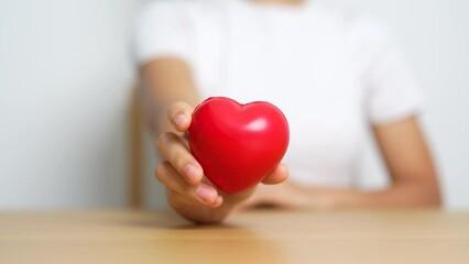 hand holding red heart shape in hospital. love, donor, world heart day, world health day, CSR donation and Insurance concepts