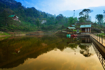 Fototapeta premium Boating spot of Chayatal or Chaya Taal, West Sikkim, India. Famous for Reflection of snow-capped Mount Kanchenjunga and Kabru on lake water, Himalayan mountains and forest surrounding.