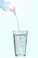 Water flows from the bottle into the glass