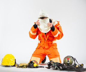 With a display of professionalism and unwavering commitment the firefighters gracefully kneel on the white background their attention fixed on the task of removing their hoods.