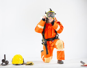 The firefighter sits attentively  his focus directed towards adjusting the straps and ensuring a...