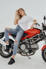 Foto op Plexiglas Studio shot of isolated in white background blond woman and custom modern motorcycle. © Fxquadro