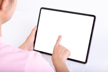 Women useing finger to touch tablet on table, tablet have white screen, rear. view from back to front of women