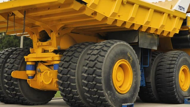 The world's biggest dumper. BelAZ 75711 from the Belarusian manufacturer BelAZ. A total of 4 are produced. Huge truck. Panorama from left to right. Close-up view