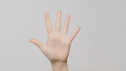 Countdown gesture. Five number. Female hand calculating fingers up on light gray background.