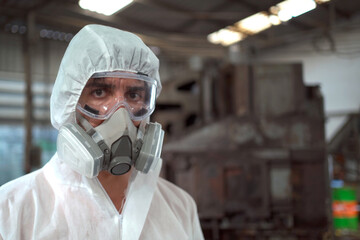Fototapeta na wymiar Team of scientist wearing a chemical protection suit and high efficiency filter face mask working in the bio - chemical contaminated factory.