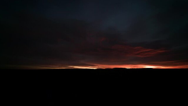 Time lapse Orange sunrise reflecting off underside of clouds