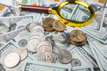 coins and magnifying glass on us dollar