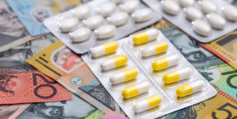 Different dispersed pills on australian dollar banknotes