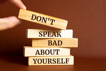 Wooden blocks with words 'Don't Speak Bad About Yourself'.