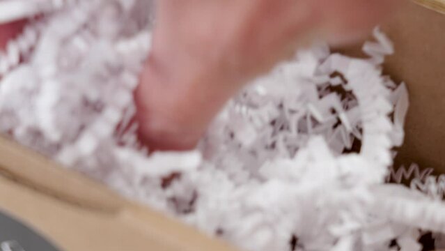 Unpacking a postal parcel with a white protective filler close up