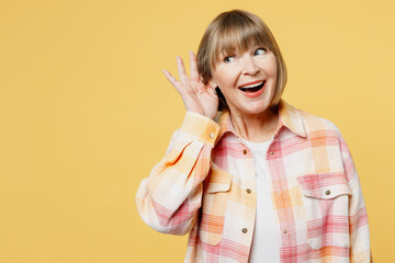 Elderly curious nosy blonde caucasian woman 50s years old she wears casual clothes try to hear you...